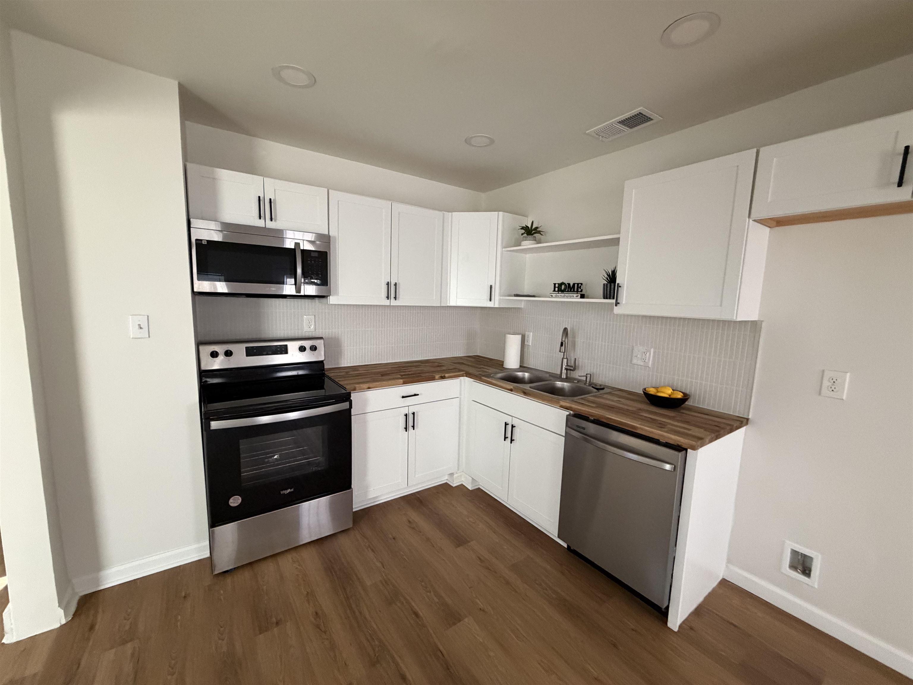 3739 Rhea Avenue Memphis, TN 38122 - Photo 8 of 10 a kitchen with granite countertop a refrigerator and a stove top oven