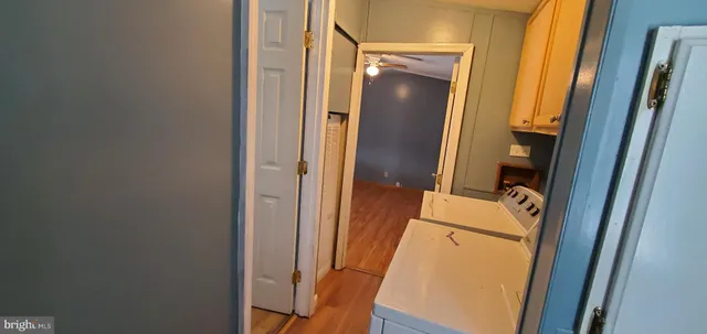 a bathroom with a granite countertop toilet and a tub