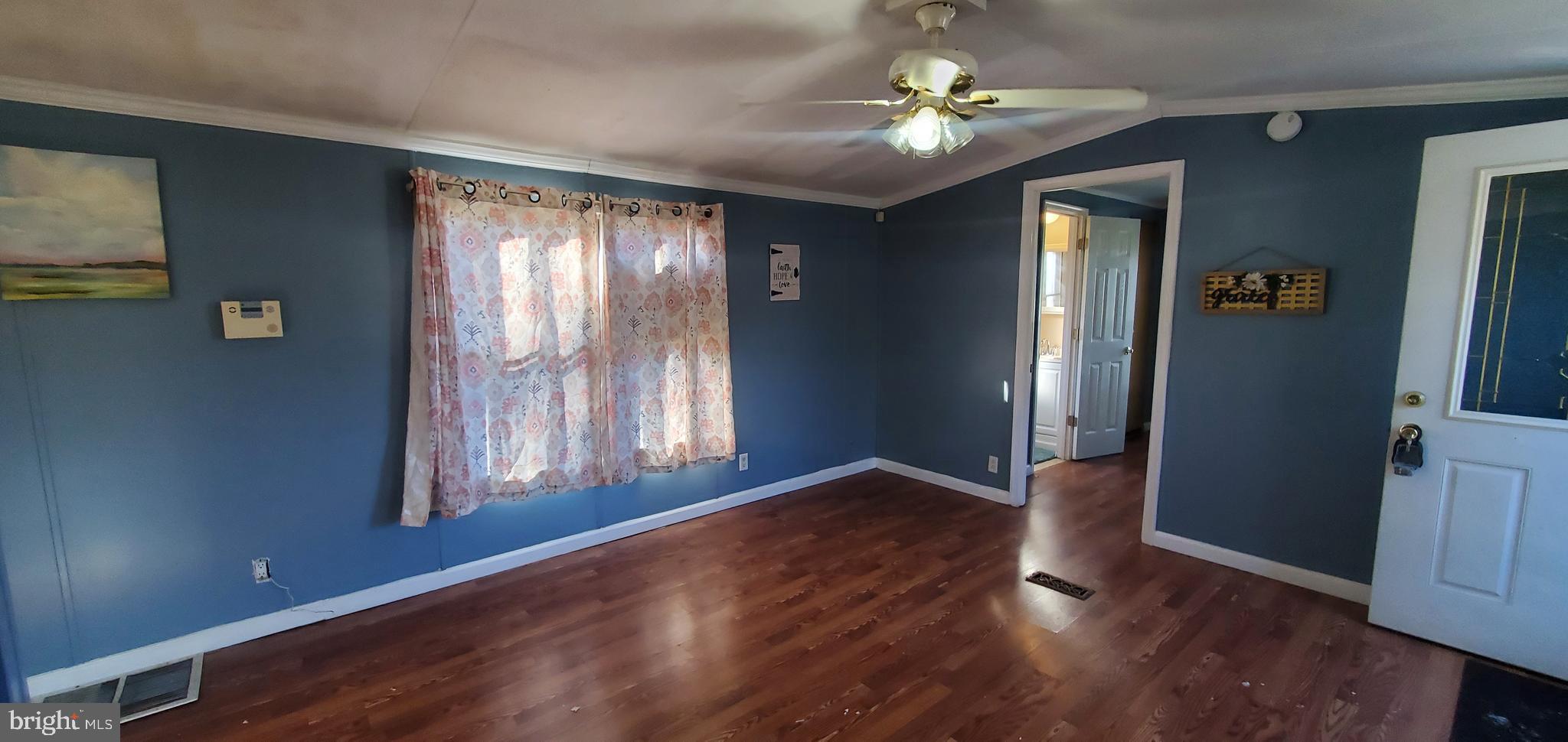 123 Wood Road Aberdeen, MD 21001 - Photo 5 of 23 a view of an empty room with window and wooden floor