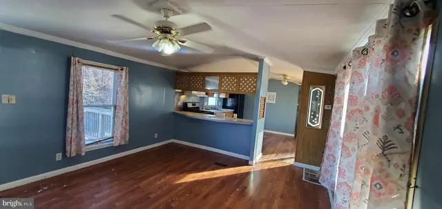 a view of kitchen with furniture and a chandelier fan