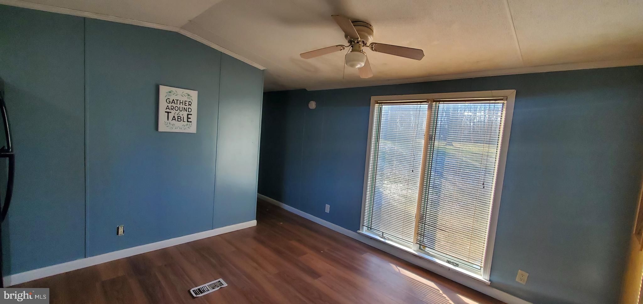 123 Wood Road Aberdeen, MD 21001 - Photo 8 of 23 an empty room with wooden floor chandelier and windows