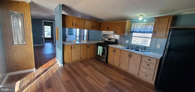 a kitchen with stainless steel appliances a refrigerator and wooden cabinets
