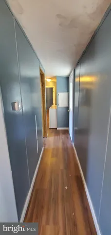 a view of hallway with wooden floor