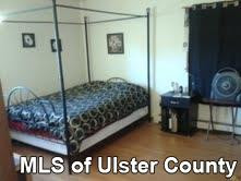 261 South Riverside Road Highland, NY 12528 - Photo 8 of 20 a bedroom with a bed and a table