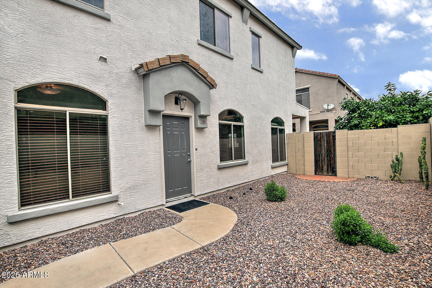 a front view of a house with garden
