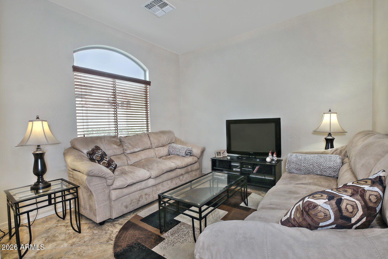 2150 East Bell Road, Unit 1069 Phoenix, AZ 85022 - Photo 15 of 33 a living room with furniture a lamp and a window