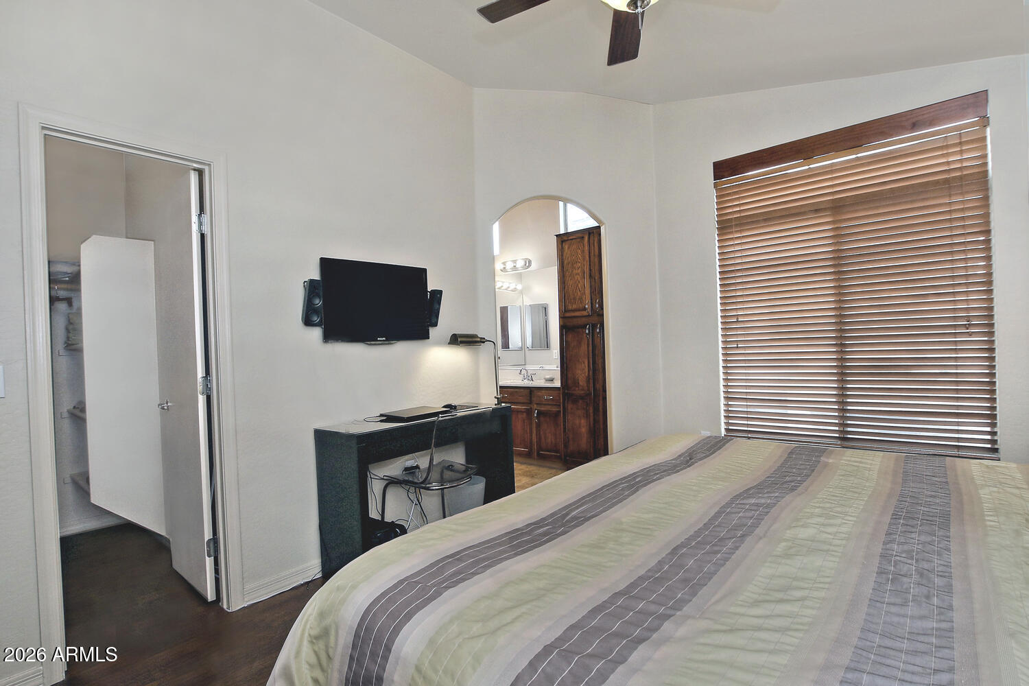 2150 East Bell Road, Unit 1069 Phoenix, AZ 85022 - Photo 20 of 33 a bedroom with a bed and a flat tv screen on dresser