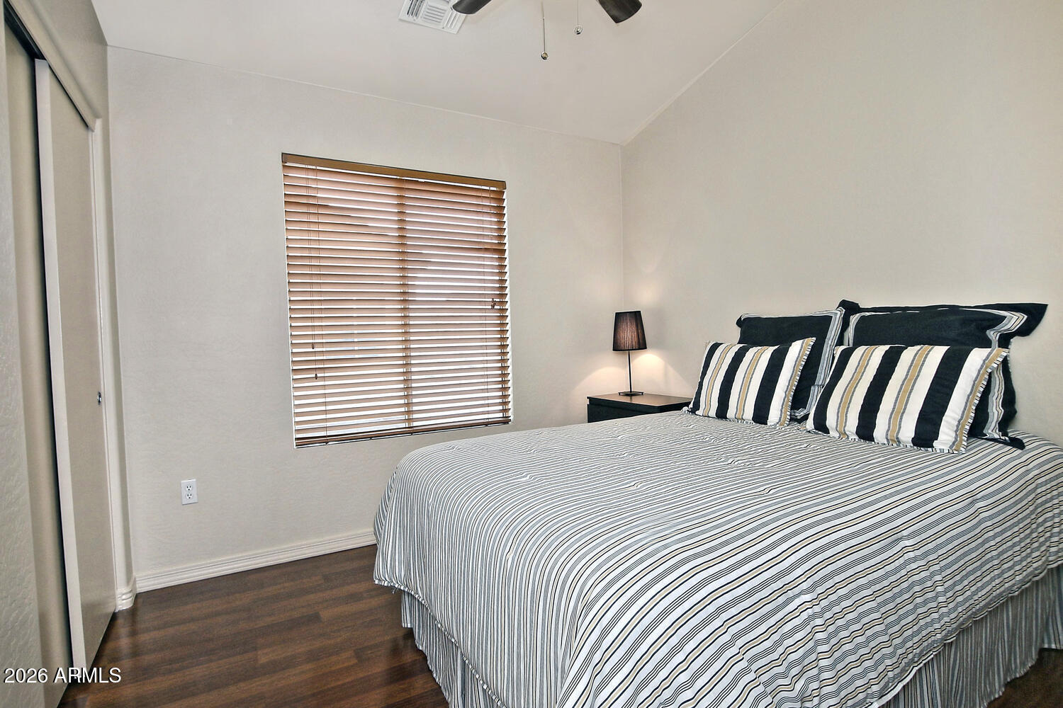 2150 East Bell Road, Unit 1069 Phoenix, AZ 85022 - Photo 26 of 33 a bedroom with a bed and wooden floor