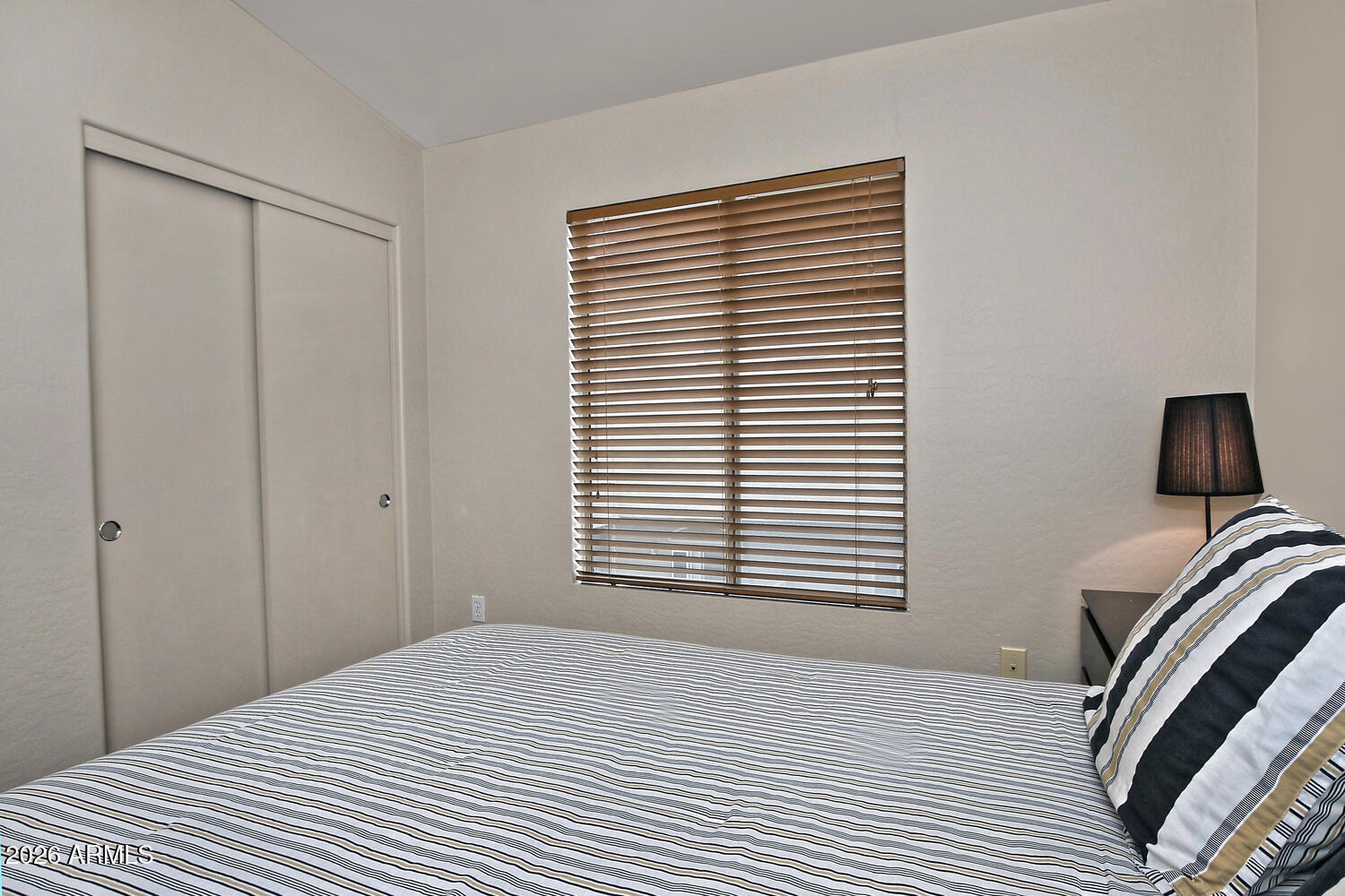 2150 East Bell Road, Unit 1069 Phoenix, AZ 85022 - Photo 27 of 33 a bedroom with a bed and a window