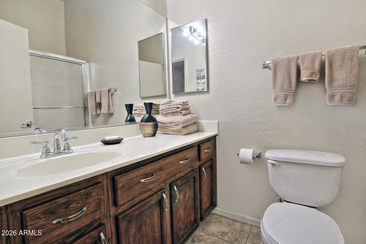 2150 East Bell Road, Unit 1069 Phoenix, AZ 85022 - Photo 30 of 33 a bathroom with a toilet sink and mirror
