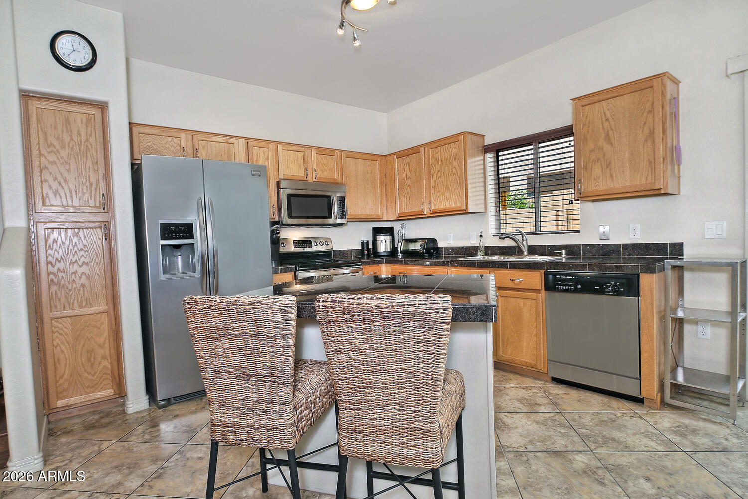 2150 East Bell Road, Unit 1069 Phoenix, AZ 85022 - Photo 9 of 33 a kitchen with stainless steel appliances granite countertop a stove top oven a sink a dining table and chairs