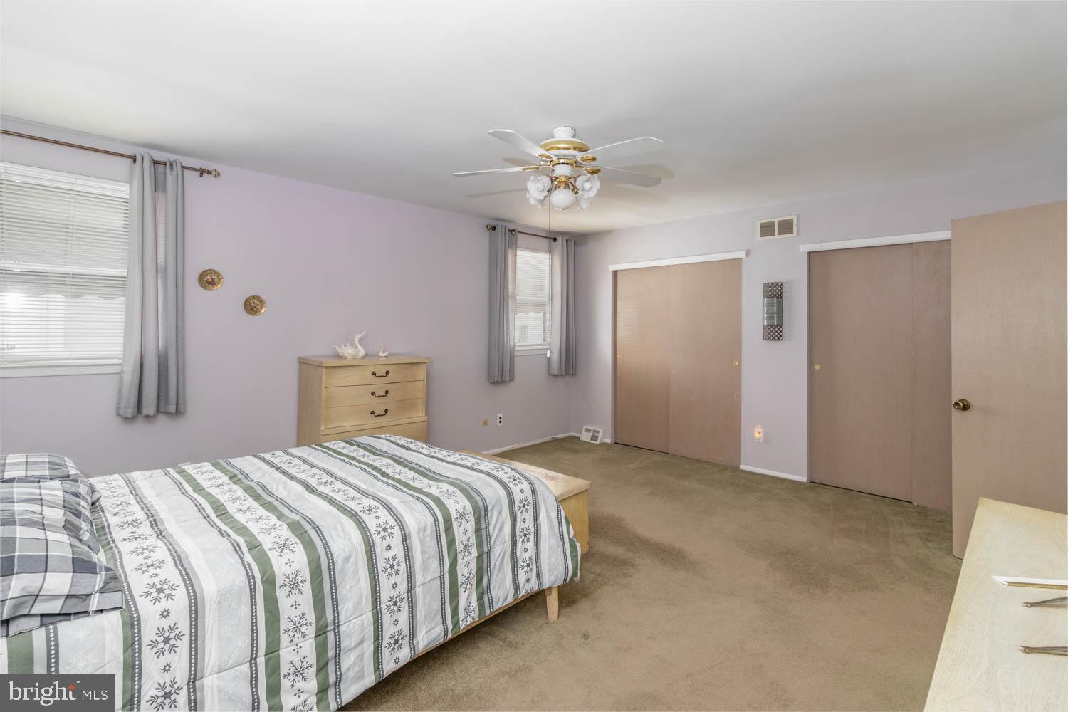 418 Densmore Road Philadelphia, PA 19116 - Photo 17 of 25 a bedroom with a bed and a chandelier