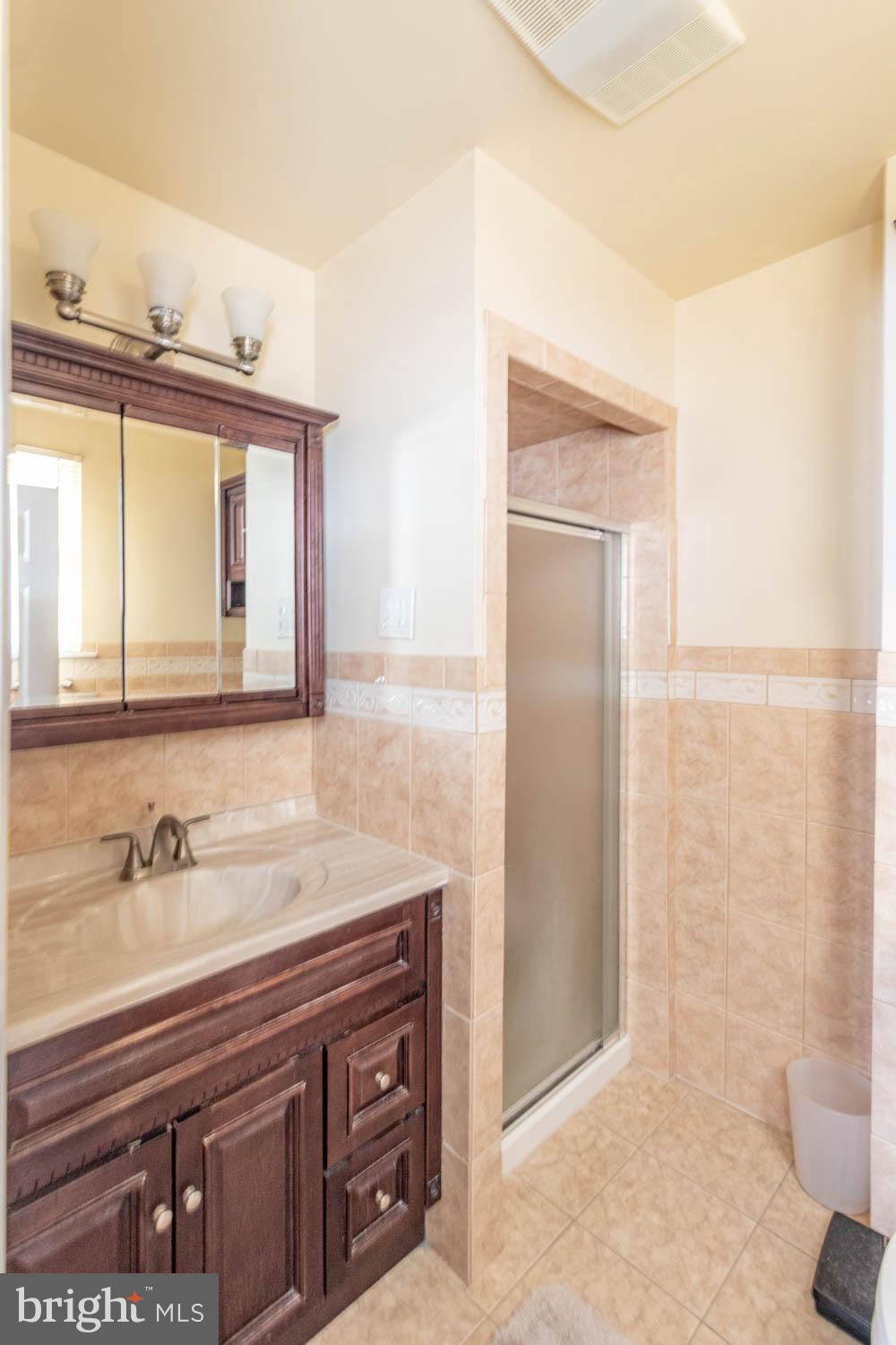 418 Densmore Road Philadelphia, PA 19116 - Photo 18 of 25 a bathroom with a sink a toilet and a mirror