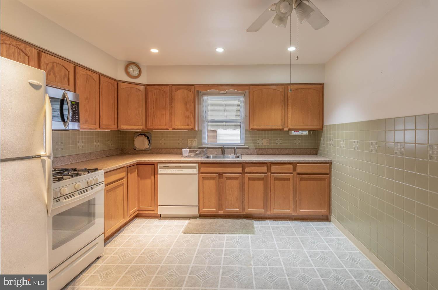 418 Densmore Road Philadelphia, PA 19116 - Photo 10 of 25 a kitchen with granite countertop a sink stainless steel appliances and cabinets
