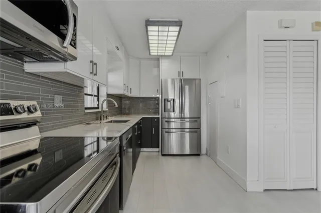 a kitchen with stainless steel appliances a refrigerator and a stove