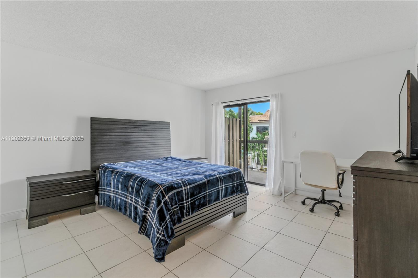 6825 Northwest 169th Street, Unit 54H Hialeah, FL 33015 - Photo 16 of 46 a living room with a bed furniture and a window
