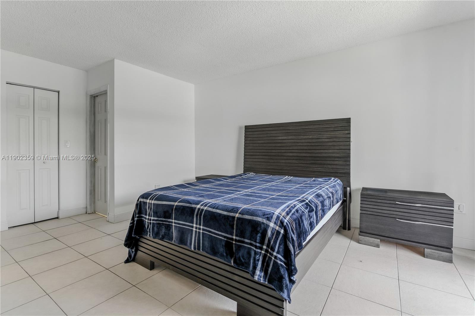 6825 Northwest 169th Street, Unit 54H Hialeah, FL 33015 - Photo 18 of 46 a bedroom with a bed and a closet