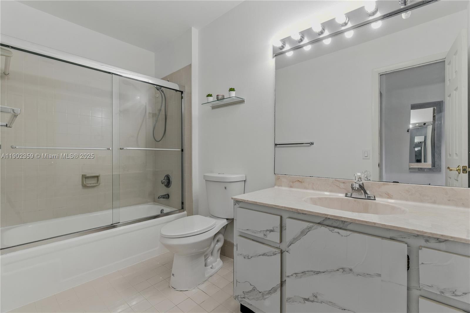 6825 Northwest 169th Street, Unit 54H Hialeah, FL 33015 - Photo 24 of 46 a bathroom with a sink toilet and shower