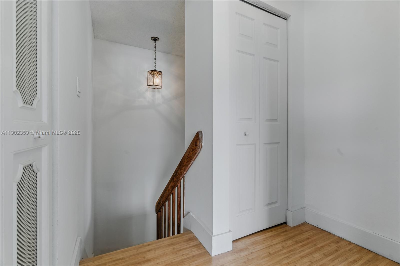 6825 Northwest 169th Street, Unit 54H Hialeah, FL 33015 - Photo 28 of 46 a view of a hallway with wooden floor and staircase