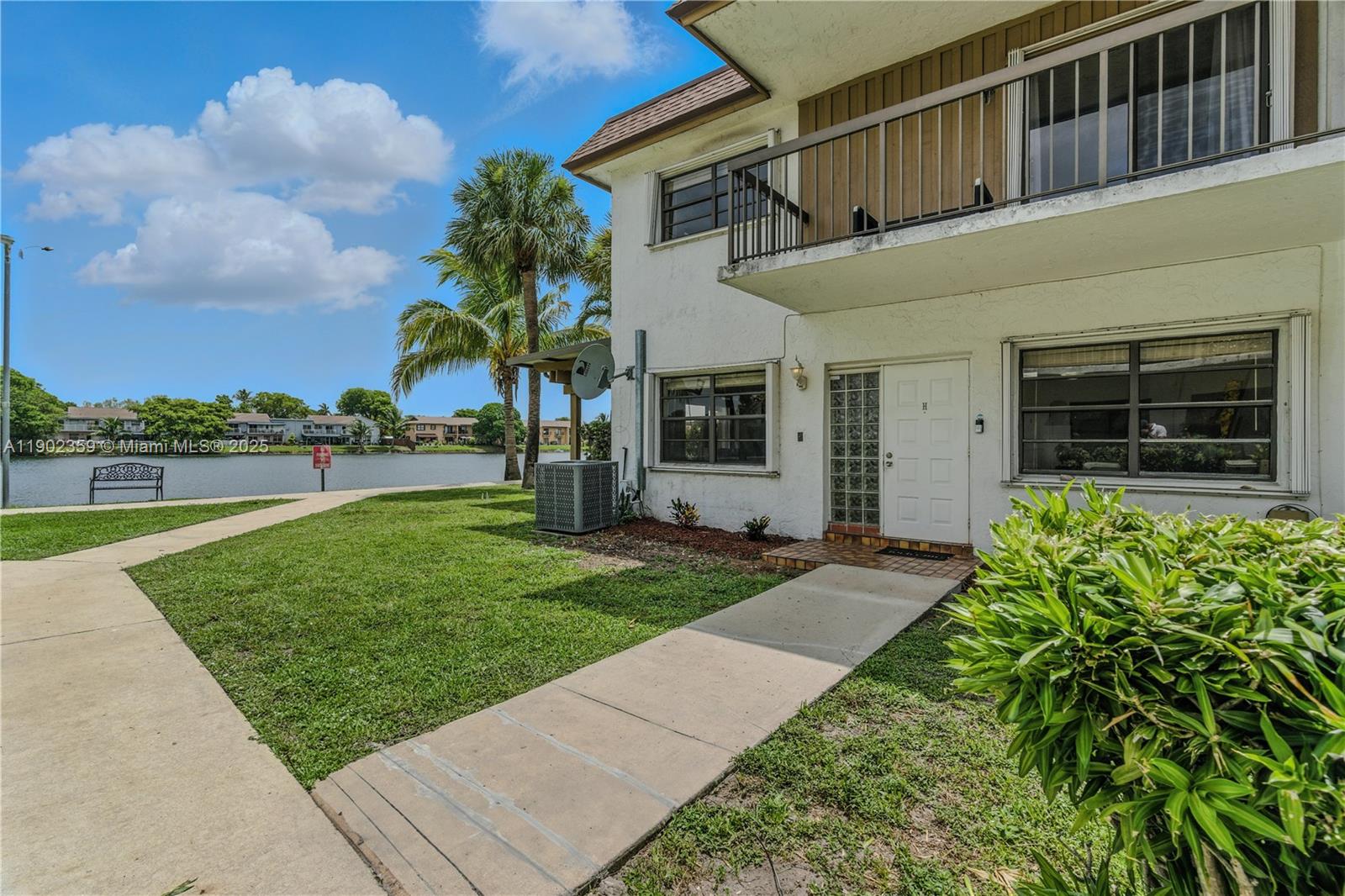 6825 Northwest 169th Street, Unit 54H Hialeah, FL 33015 - Photo 29 of 46 a view of a house with a yard