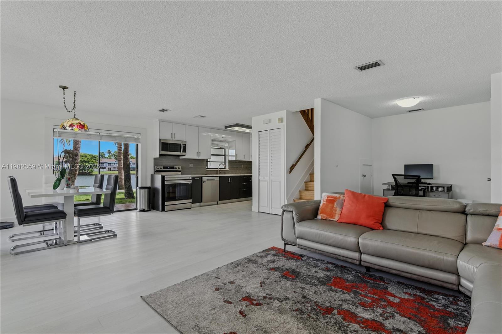 6825 Northwest 169th Street, Unit 54H Hialeah, FL 33015 - Photo 3 of 46 a living room with furniture and a rug
