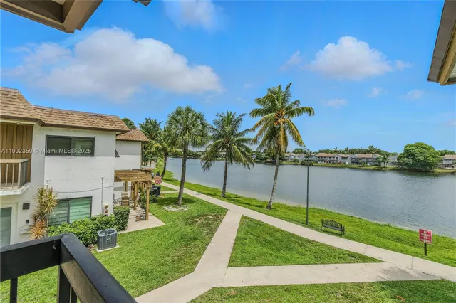 a view of a house with yard and lake view