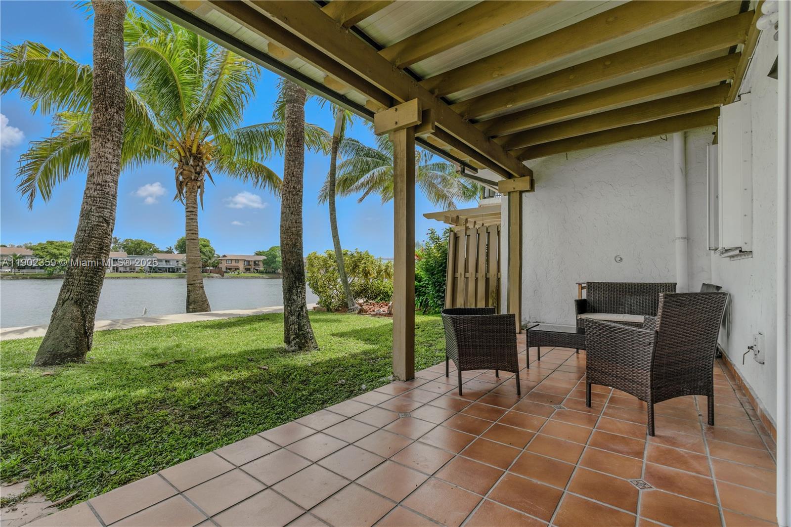 6825 Northwest 169th Street, Unit 54H Hialeah, FL 33015 - Photo 33 of 46 a view of a chairs and table in the patio