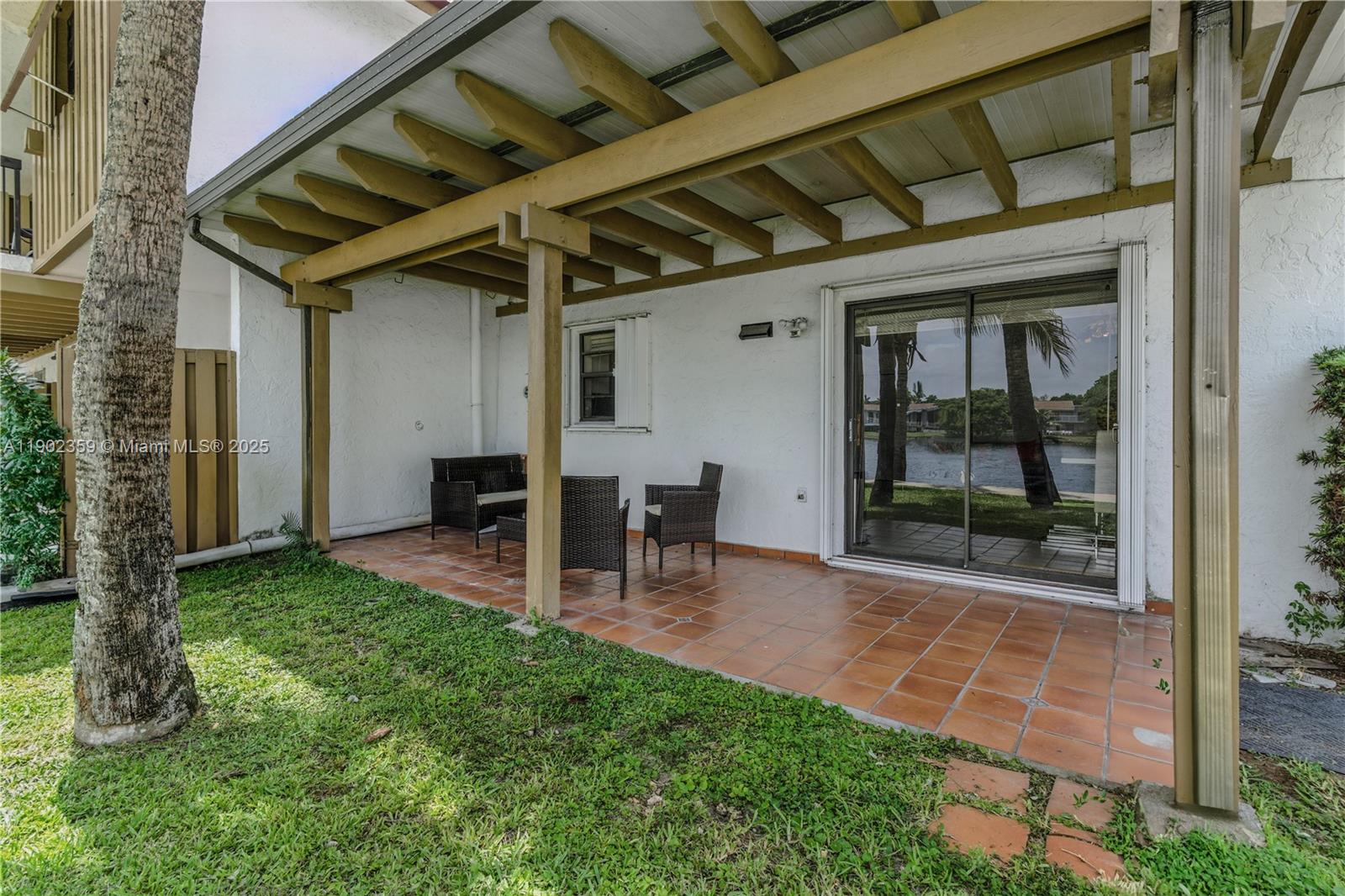 6825 Northwest 169th Street, Unit 54H Hialeah, FL 33015 - Photo 35 of 46 a view of a porch with table and chairs and potted plants
