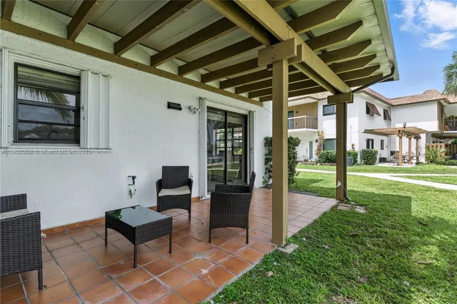 a view of a porch with chairs and backyard