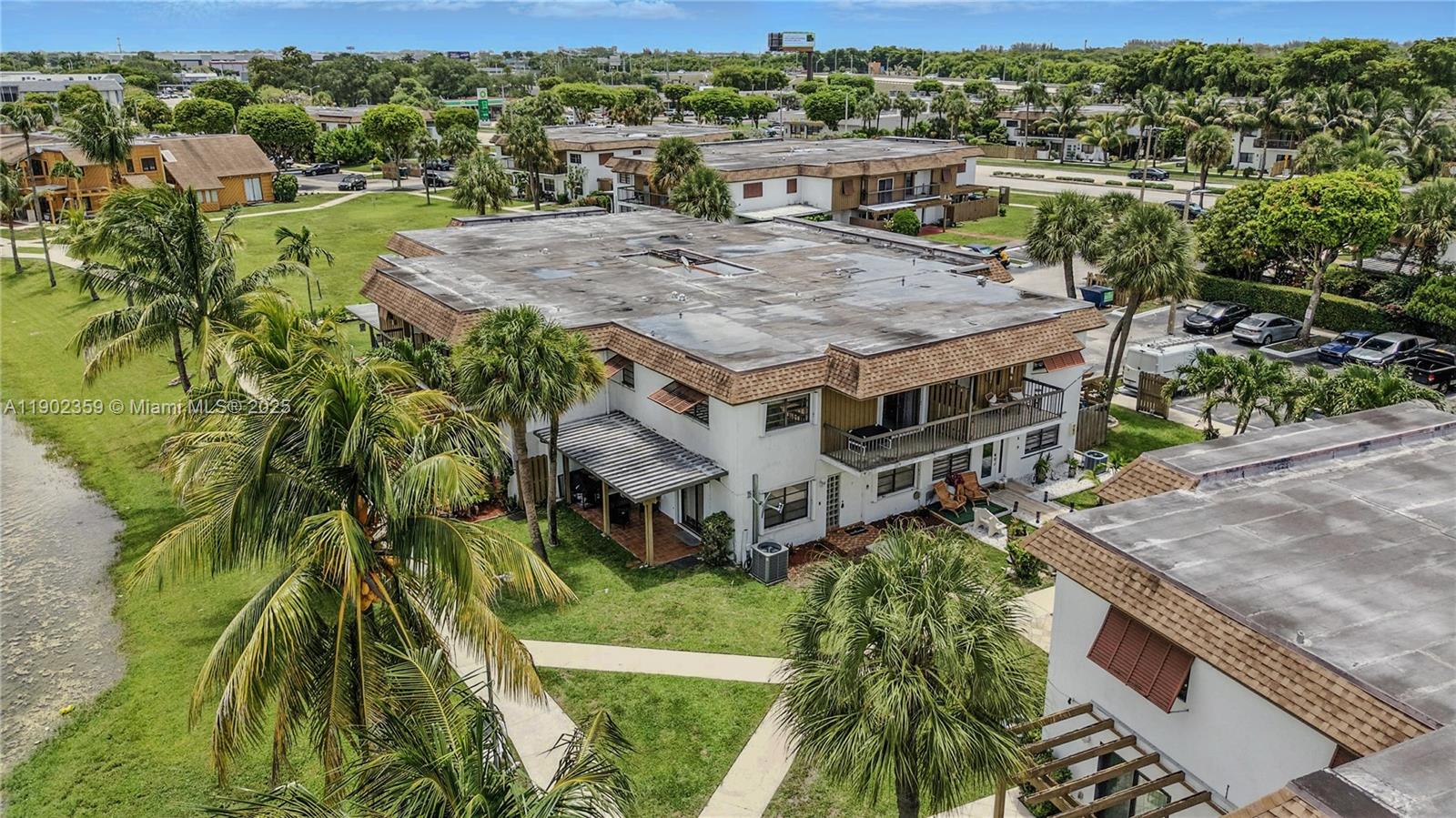 6825 Northwest 169th Street, Unit 54H Hialeah, FL 33015 - Photo 38 of 46 a view of a house with a yard