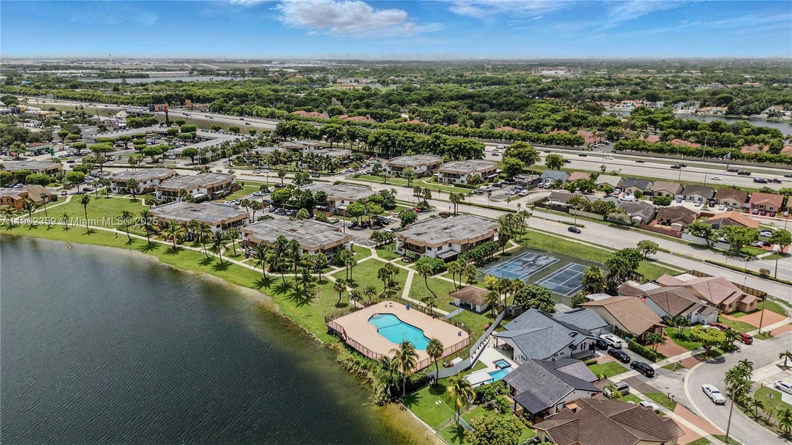 6825 Northwest 169th Street, Unit 54H Hialeah, FL 33015 - Photo 41 of 46 an aerial view of residential houses with outdoor space and river
