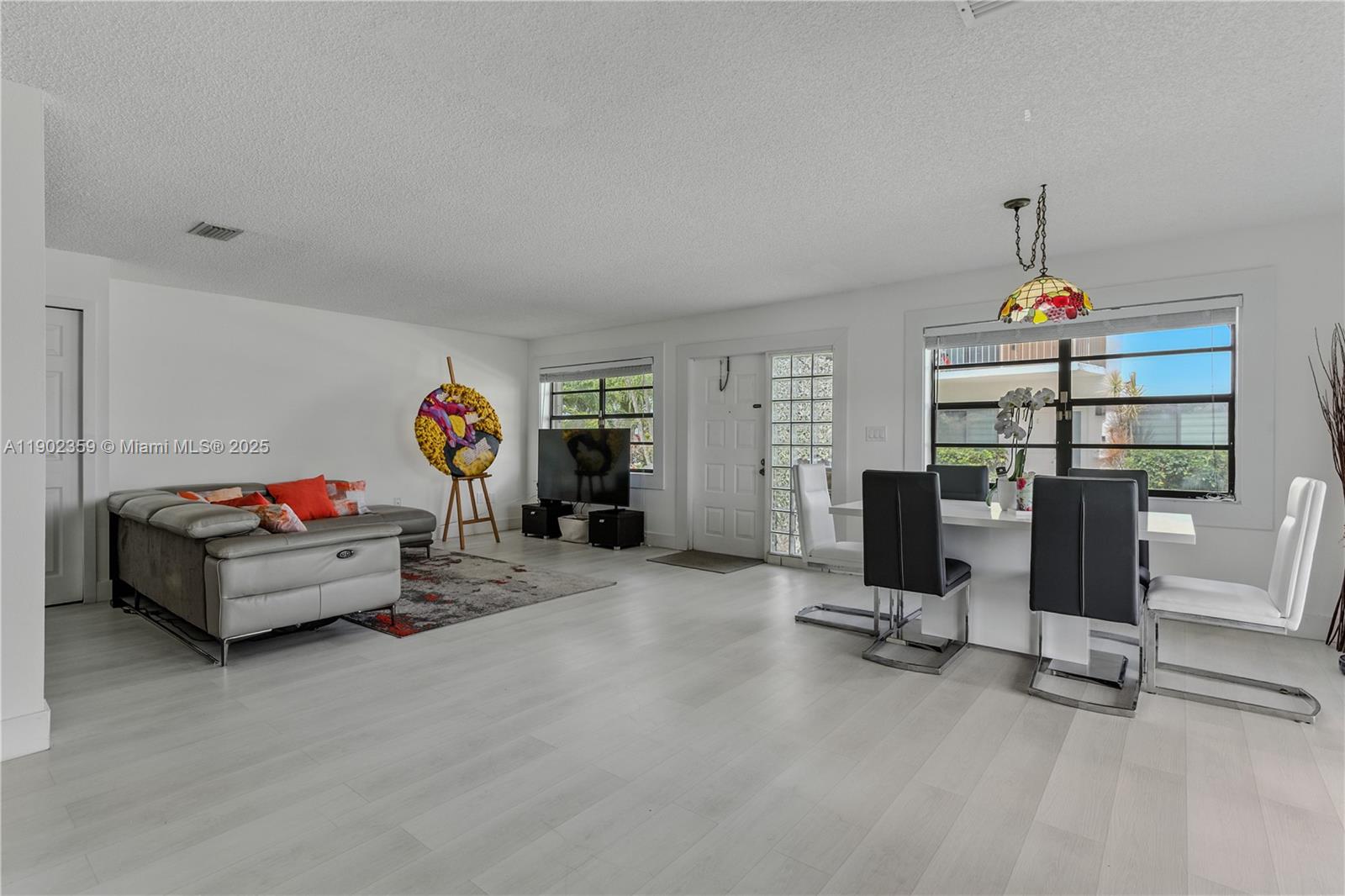 6825 Northwest 169th Street, Unit 54H Hialeah, FL 33015 - Photo 6 of 46 a living room with furniture and a flat screen tv