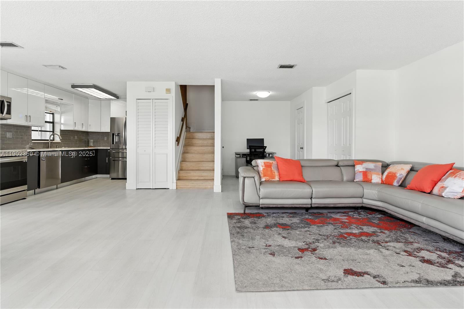 6825 Northwest 169th Street, Unit 54H Hialeah, FL 33015 - Photo 7 of 46 a living room with furniture and kitchen view