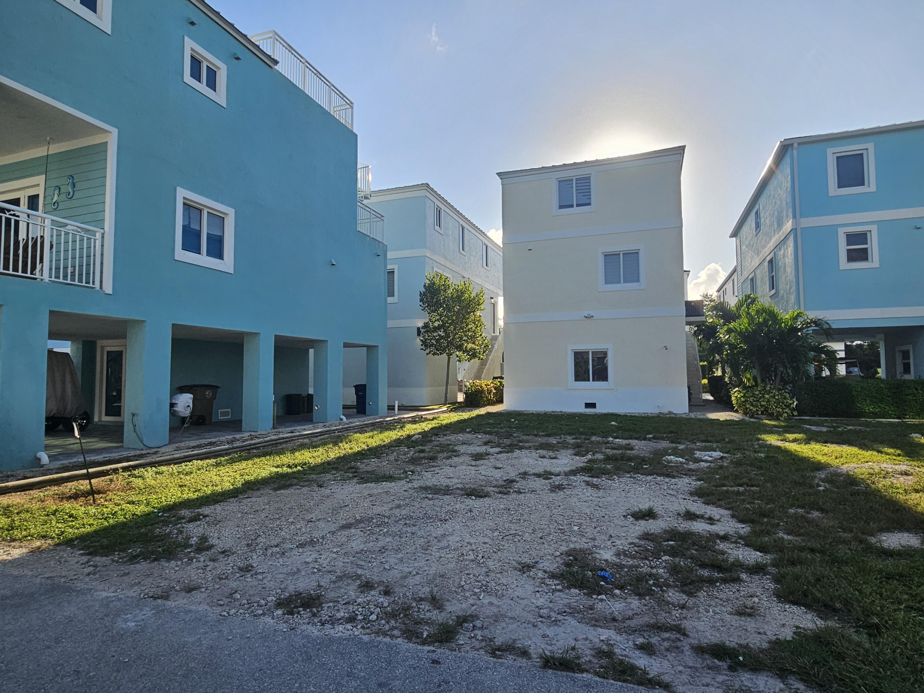 94825 Overseas Highway, Unit 68 Key Largo, FL 33037 - Photo 2 of 28 a view of a house with a yard
