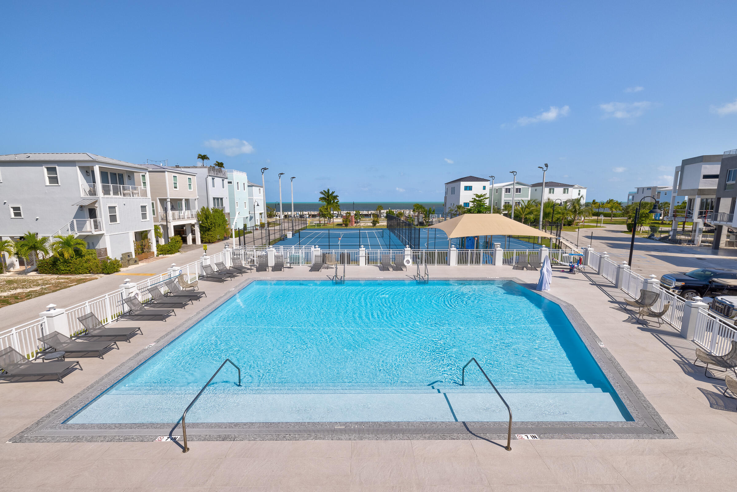 94825 Overseas Highway, Unit 68 Key Largo, FL 33037 - Photo 25 of 28 a view of a swimming pool and lounge chair