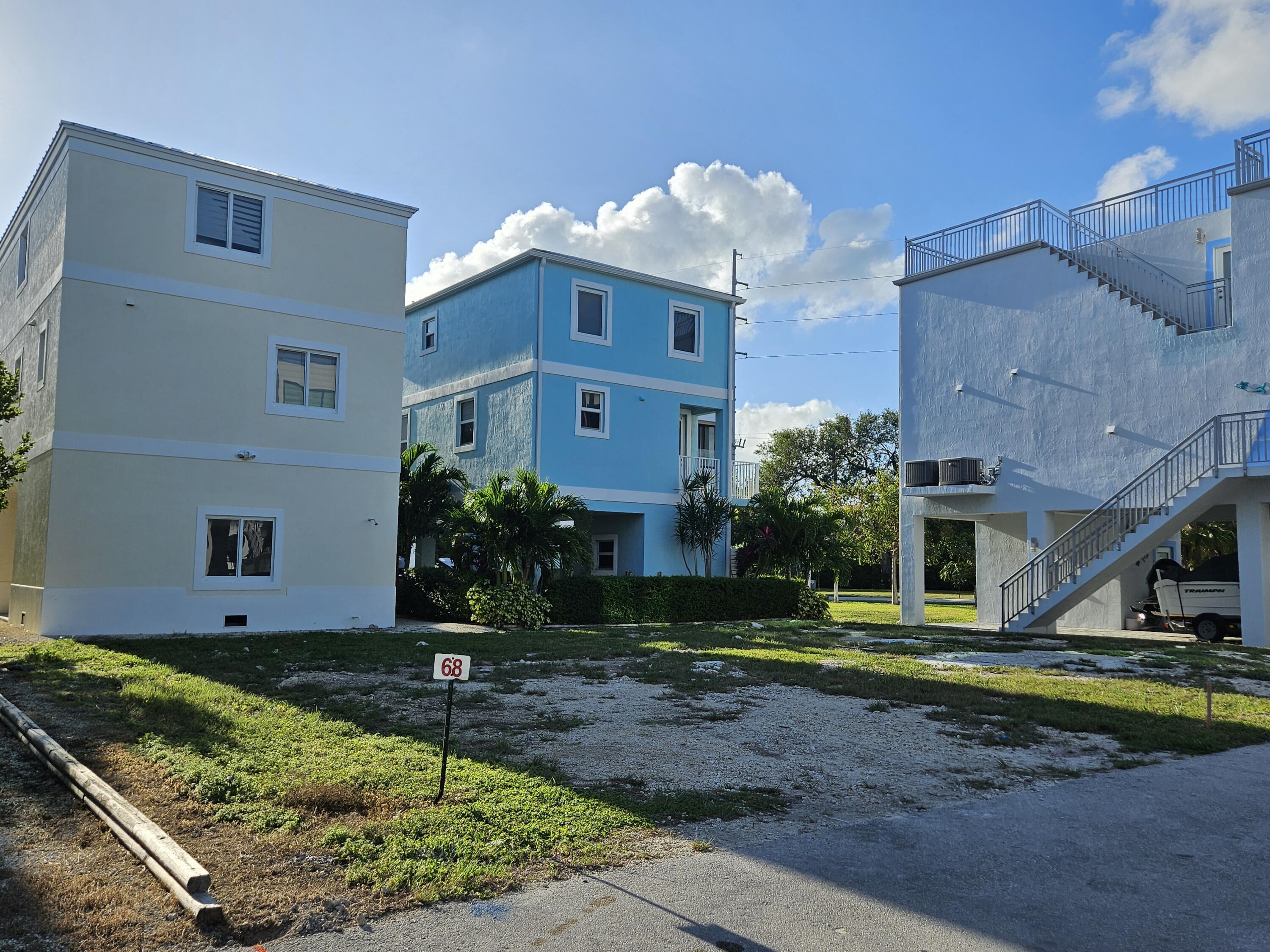 94825 Overseas Highway, Unit 68 Key Largo, FL 33037 - Photo 3 of 28 a view of a house with backyard and garden