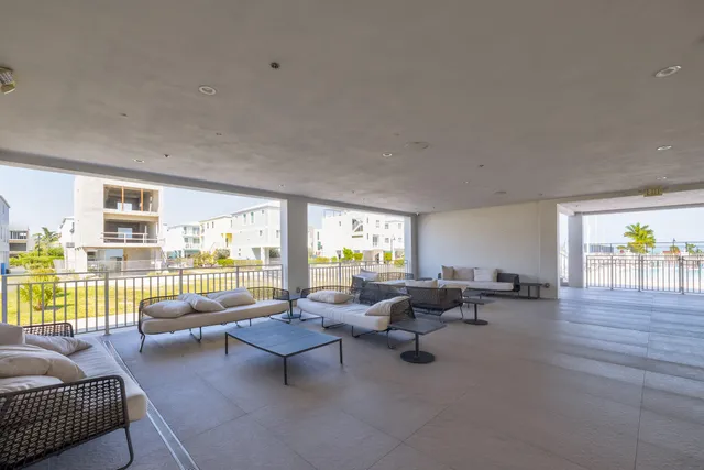 a living room with furniture and floor to ceiling window