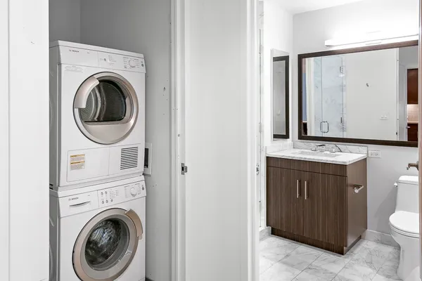 a bathroom with a sink a washer and dryer