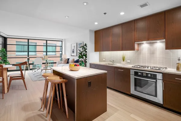 a kitchen with stainless steel appliances granite countertop a stove a sink and a refrigerator