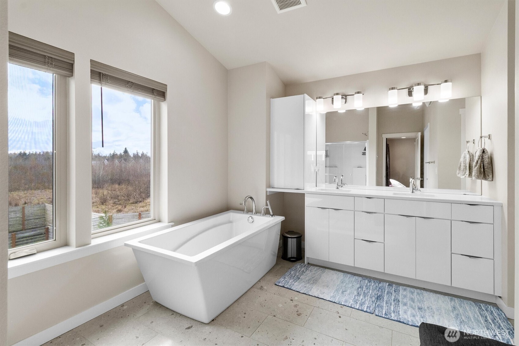 703 Northview Street Bellingham, WA 98226 - Photo 23 of 40 a spacious bathroom with a double vanity sink large mirror and a bathtub