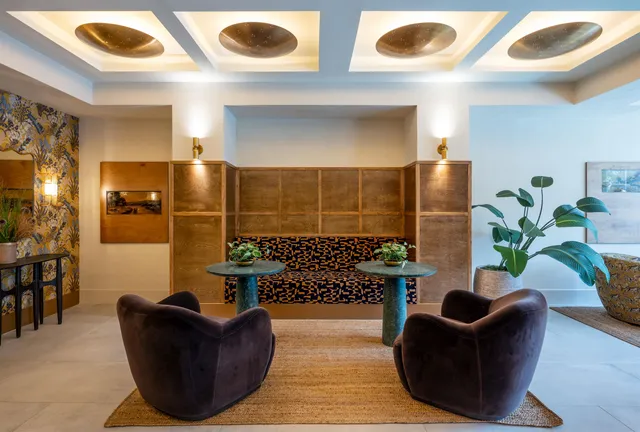 a lobby with furniture and a rug