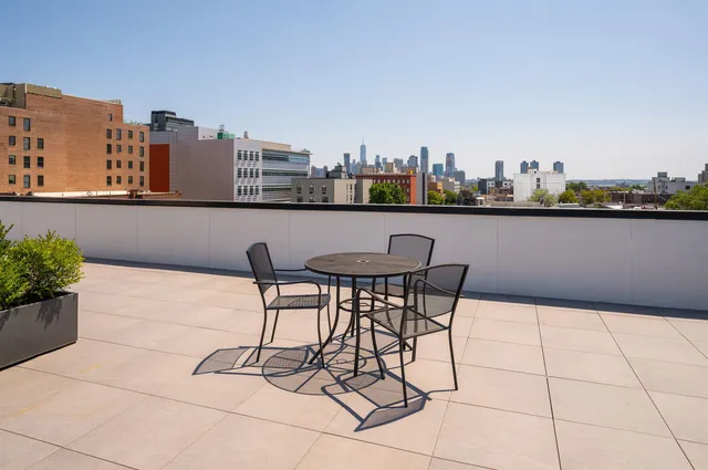 a terrace with outdoor seating and city view