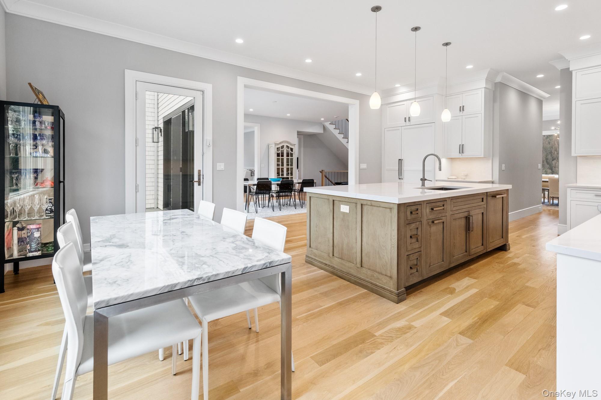 240 Head Of Pond Road Water Mill, NY 11976 - Photo 15 of 40 Kitchen featuring a large island with sink, a sink, white cabinetry, light wood-style flooring, and recessed lighting