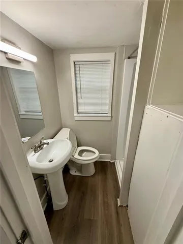 a white toilet sitting next to a bathroom sink