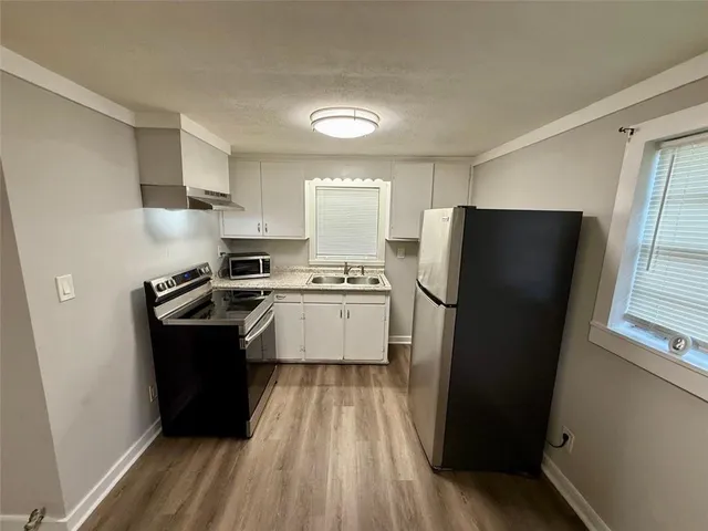 a kitchen with a refrigerator a sink and dishwasher