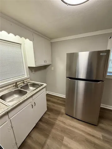 a kitchen with stainless steel appliances granite countertop a refrigerator a sink and a stove