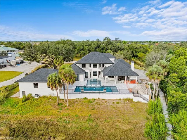 an aerial view of a house with a big yard