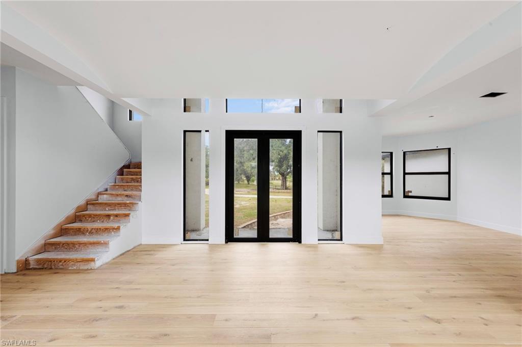 5461 Park Road Fort Myers, FL 33908 - Photo 14 of 41 a view of an empty room with wooden floor and stairs
