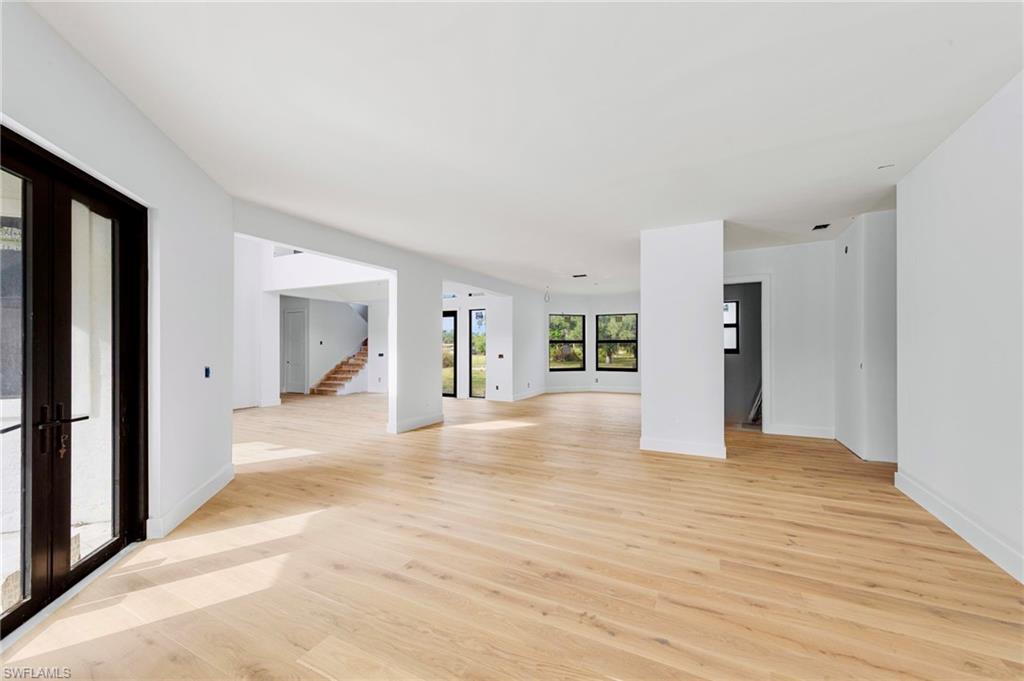 5461 Park Road Fort Myers, FL 33908 - Photo 16 of 41 a view of a hallway with wooden floor and a refrigerator