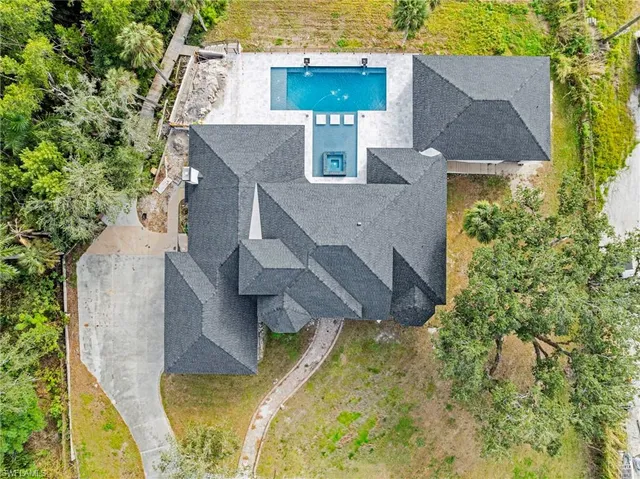 an aerial view of a house with swimming pool